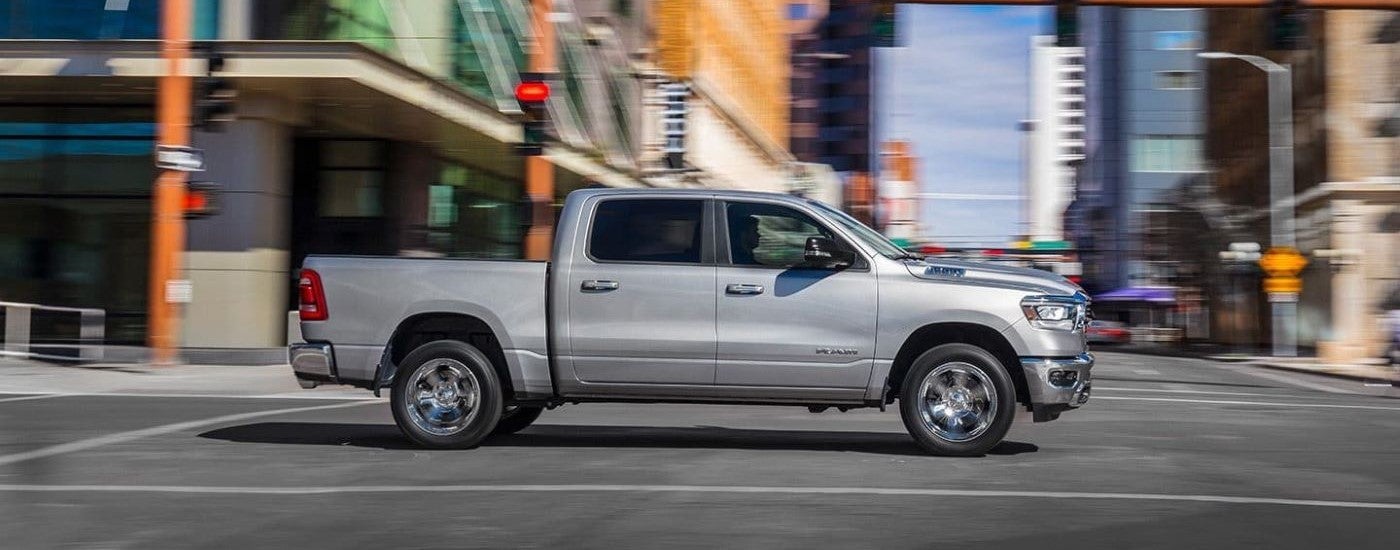 Silver 2019 Ram 1500 driving through a city