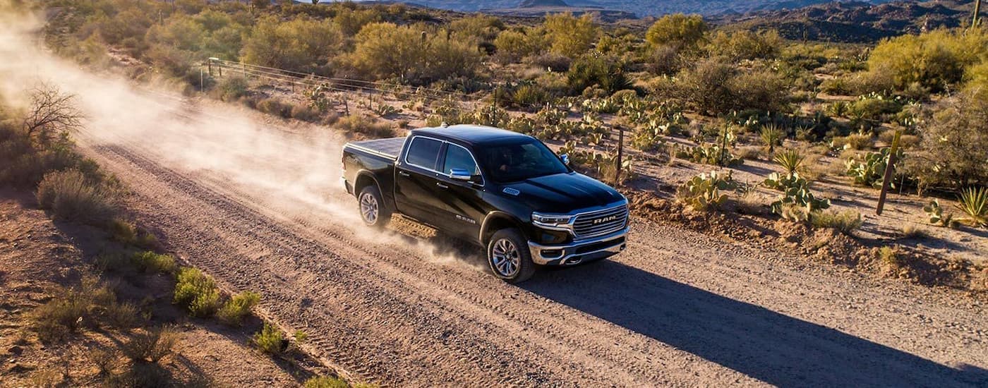 Black 2019 Ram 1500 driving along a trail