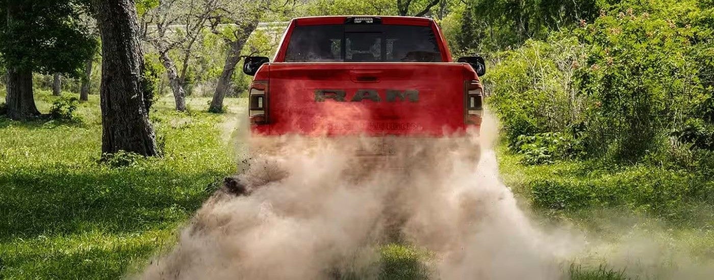 Rear of a red 2023 Ram 2500 Power Wagon driving off-road