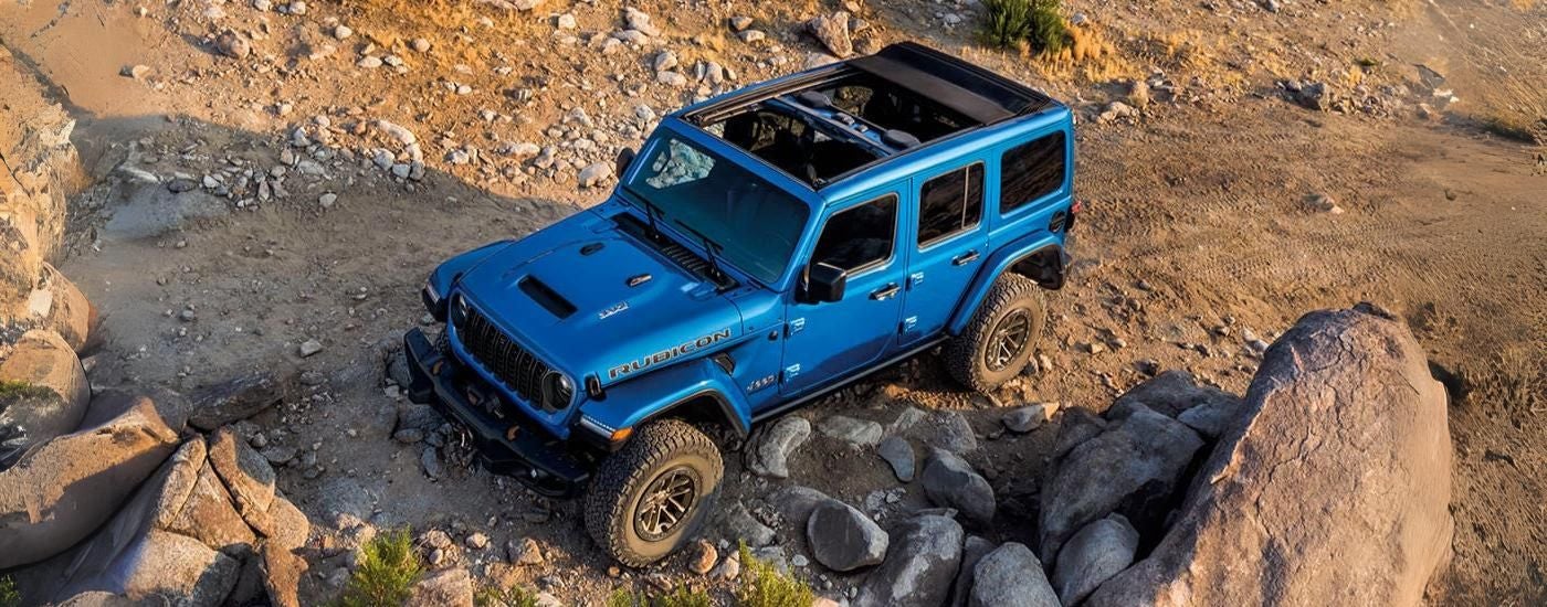 Blue 2026 Jeep Wrangler Rubicon 392 parked on rocks