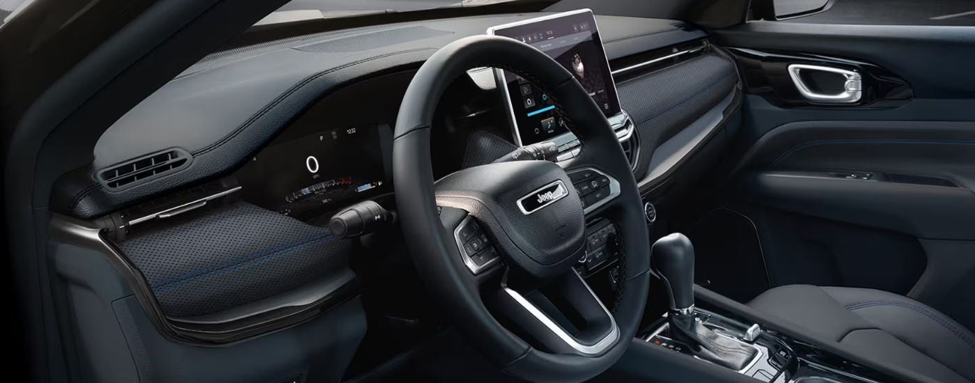 The digital cluster and steering wheel on a 2026 Jeep Compass.