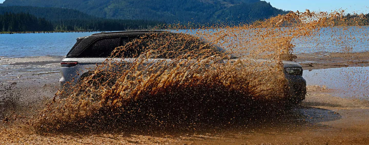 Silver 2026 Jeep Grand Cherokee kicking up mud