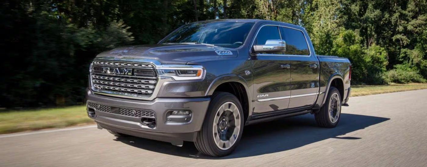 Grey 2027 Ram 1500 driving on a paved road.