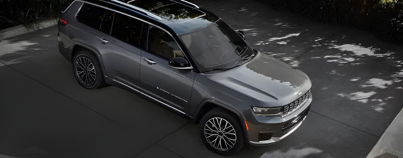 A grey 2024 Jeep Grand Cherokee is shown from the front at an angle.