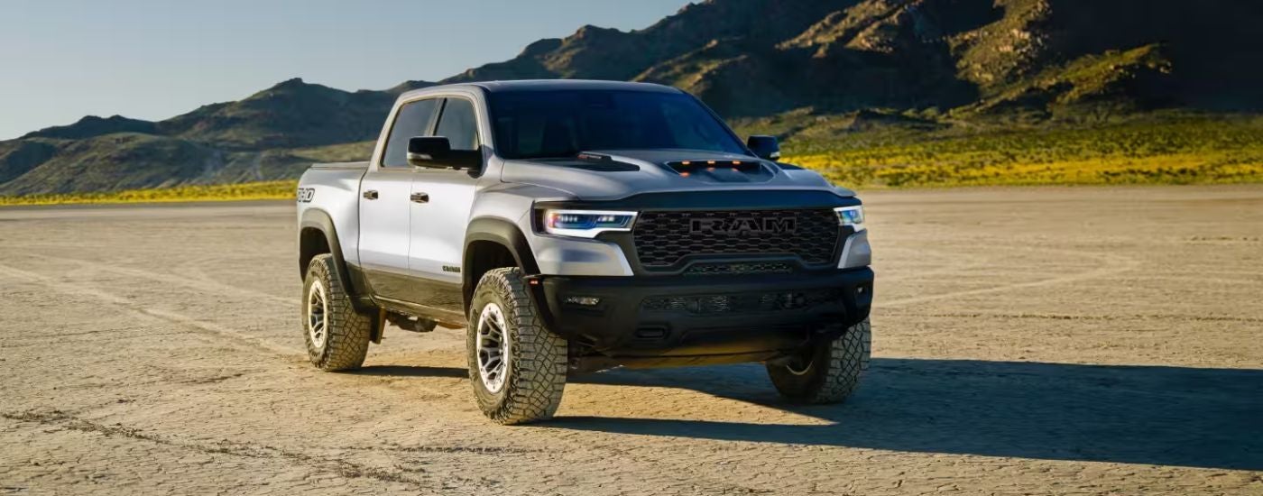 A silver 2027 Ram 1500 RHO parked off-road.
